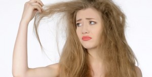 Frizzy-hairdehydrated-hair-image-of-a-model-looking-worringly-at-her-hairs-700x357